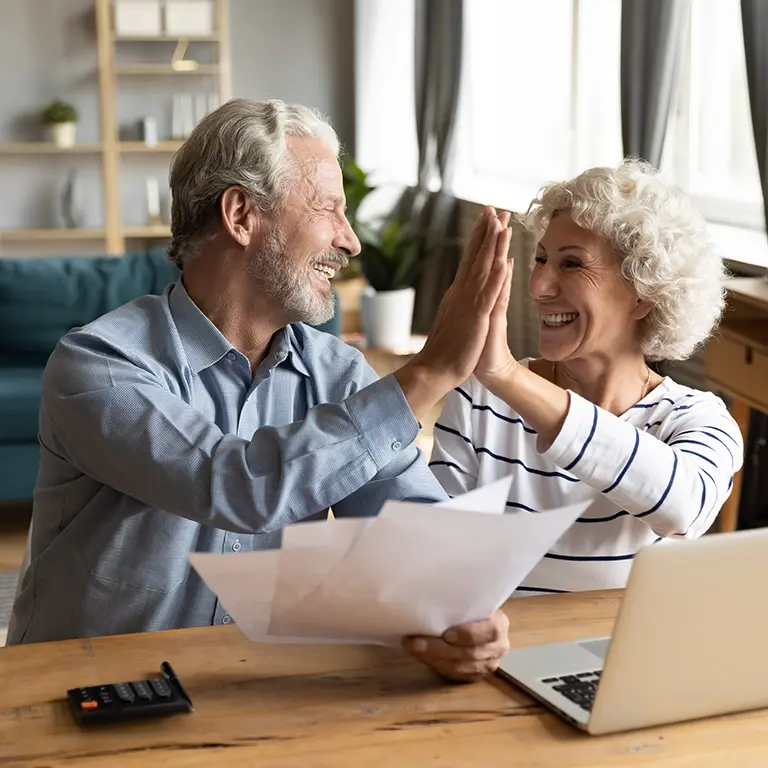 Couple celebrating signed documents
