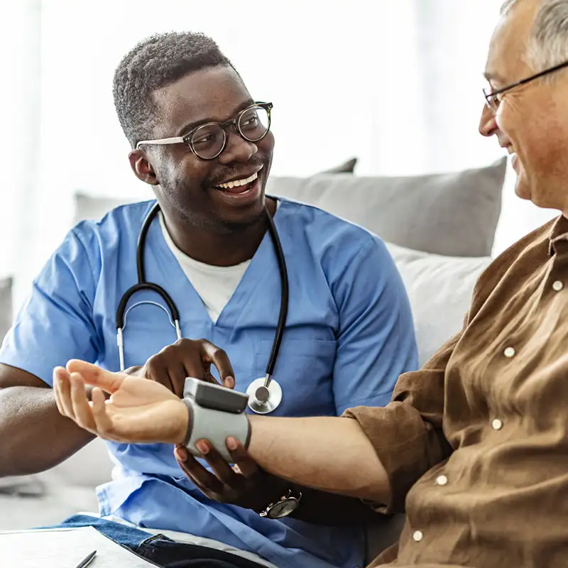 A male physician taking a patient's blood pressure 