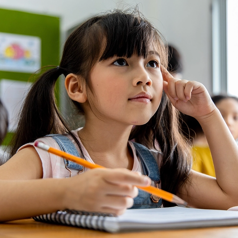 Girl at school desk (768x768 accordion image)