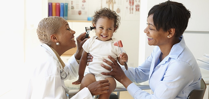 Doctor caring for woman and baby