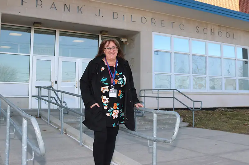 Woman posing infront of a New Britain school