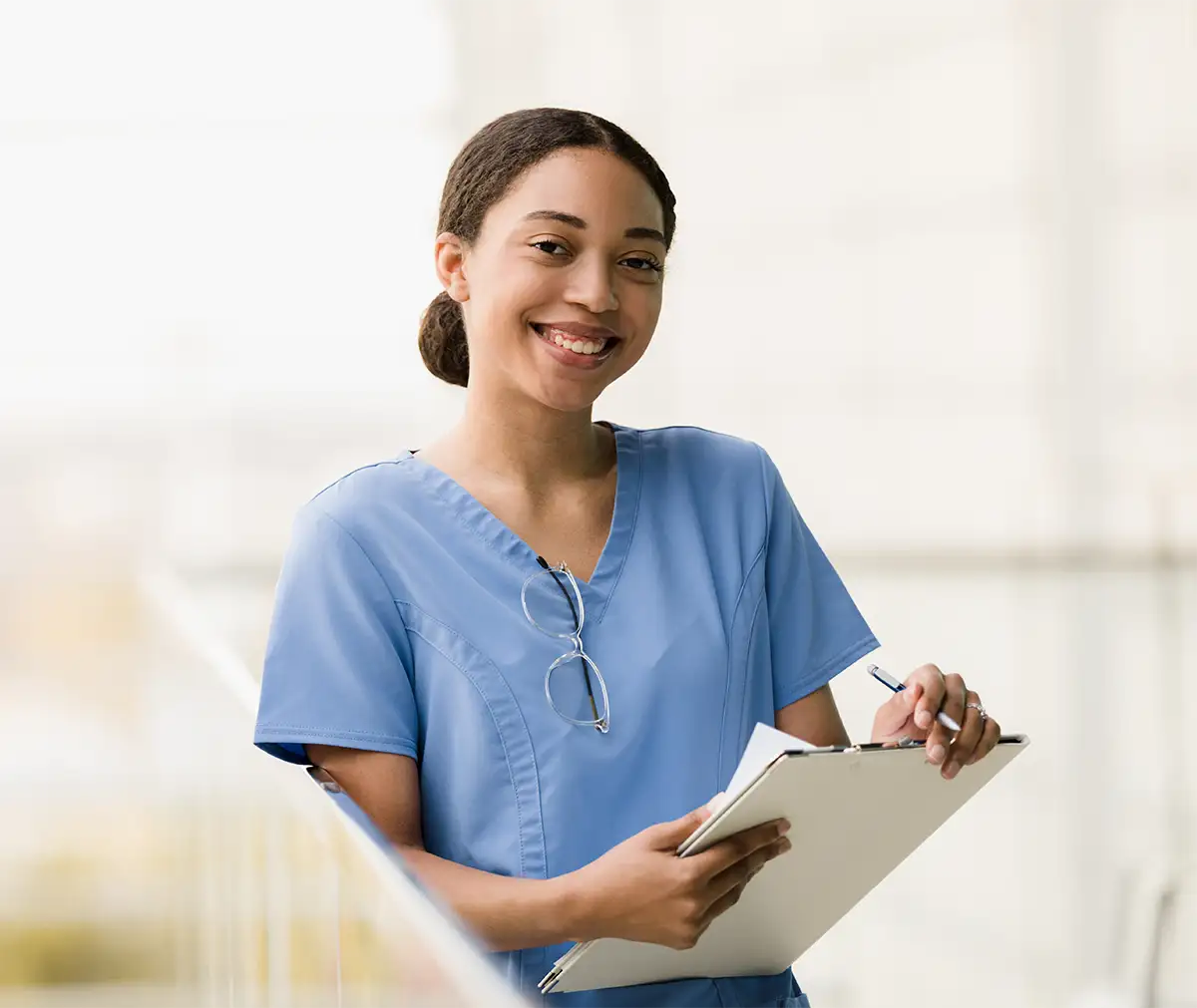 A smiling nurse with a clipboard