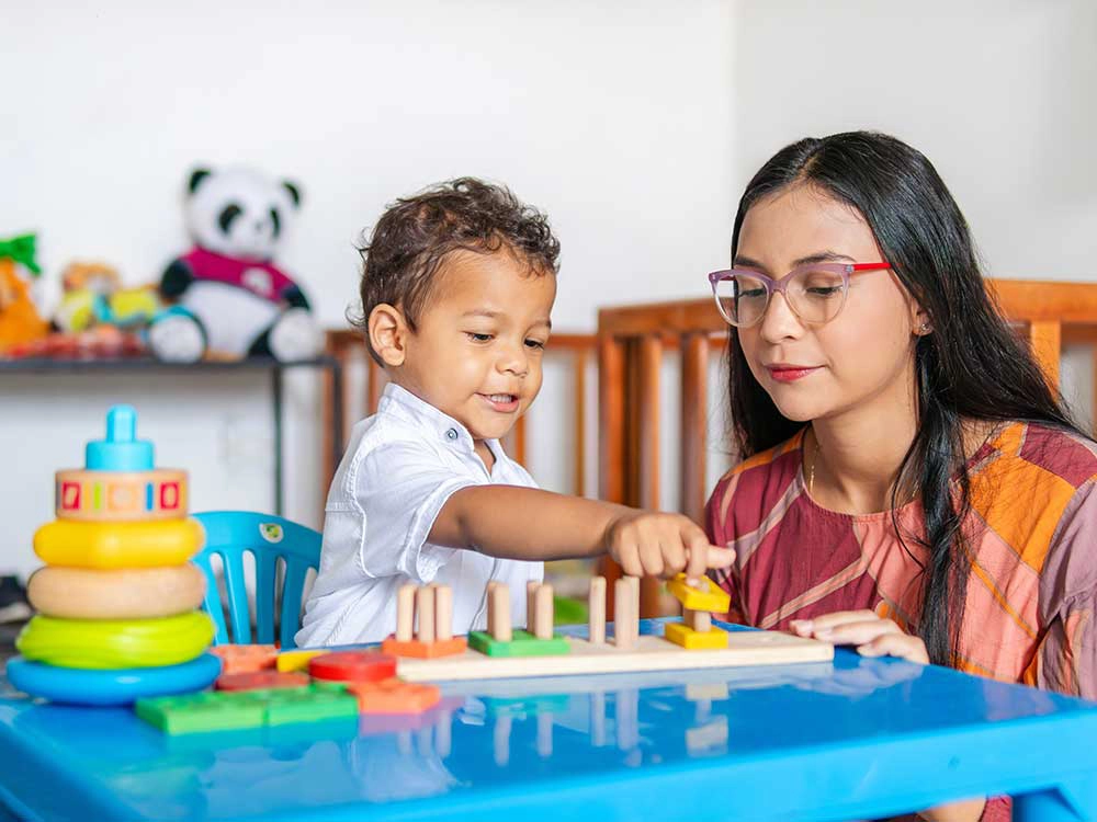 Early childhood professional and young child (Image 1000x750).webp